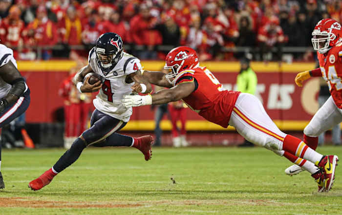 Jan 12, 2020; Kansas City, Missouri, USA; Houston Texans quarterback Deshaun Watson (4) runs against Kansas City Chiefs nose tackle Derrick Nnadi (91) during the second half in a AFC Divisional Round playoff football game at Arrowhead Stadium. Mandatory Credit: Jay Biggerstaff-USA TODAY Sports